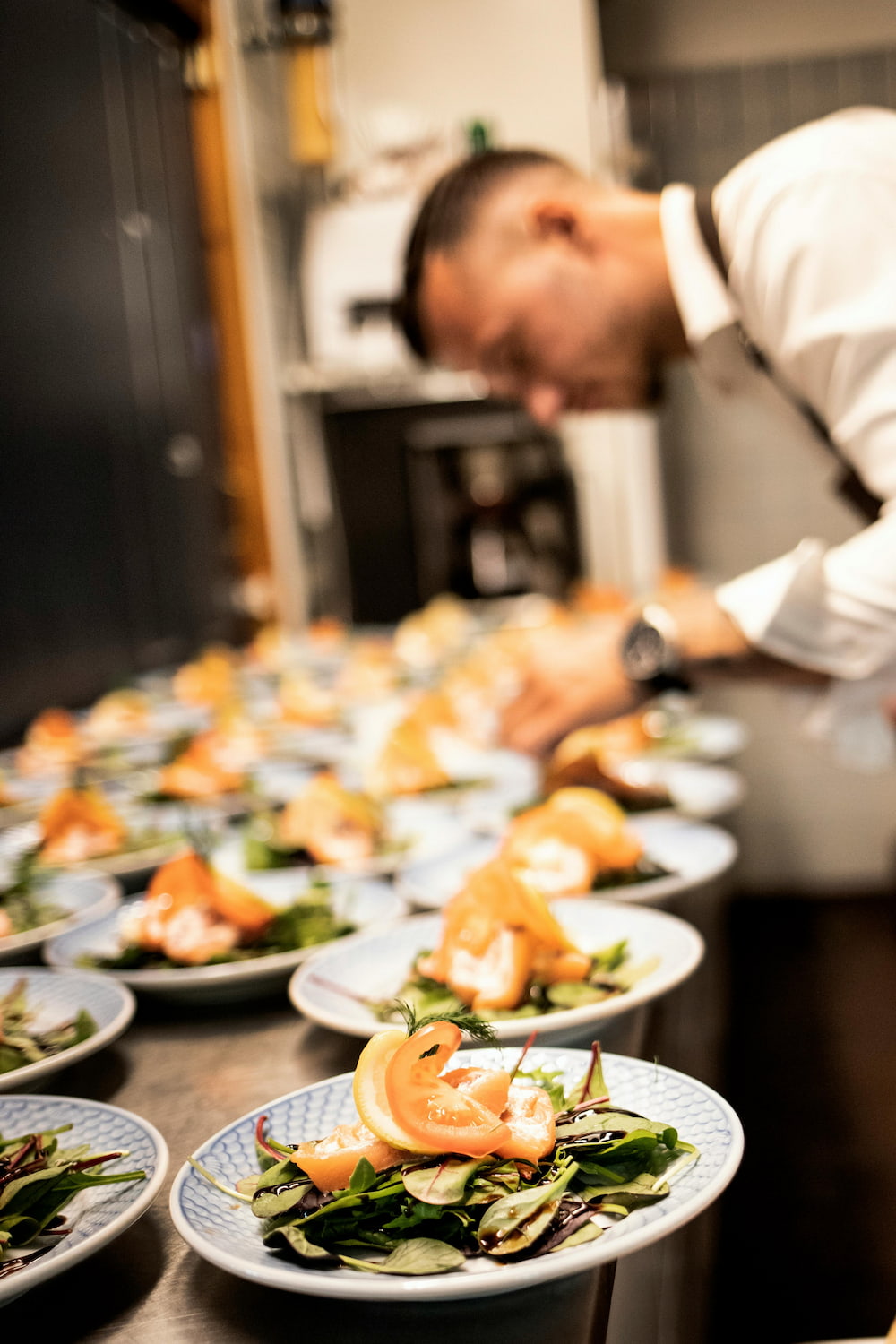 Chef dishing a salmon plate