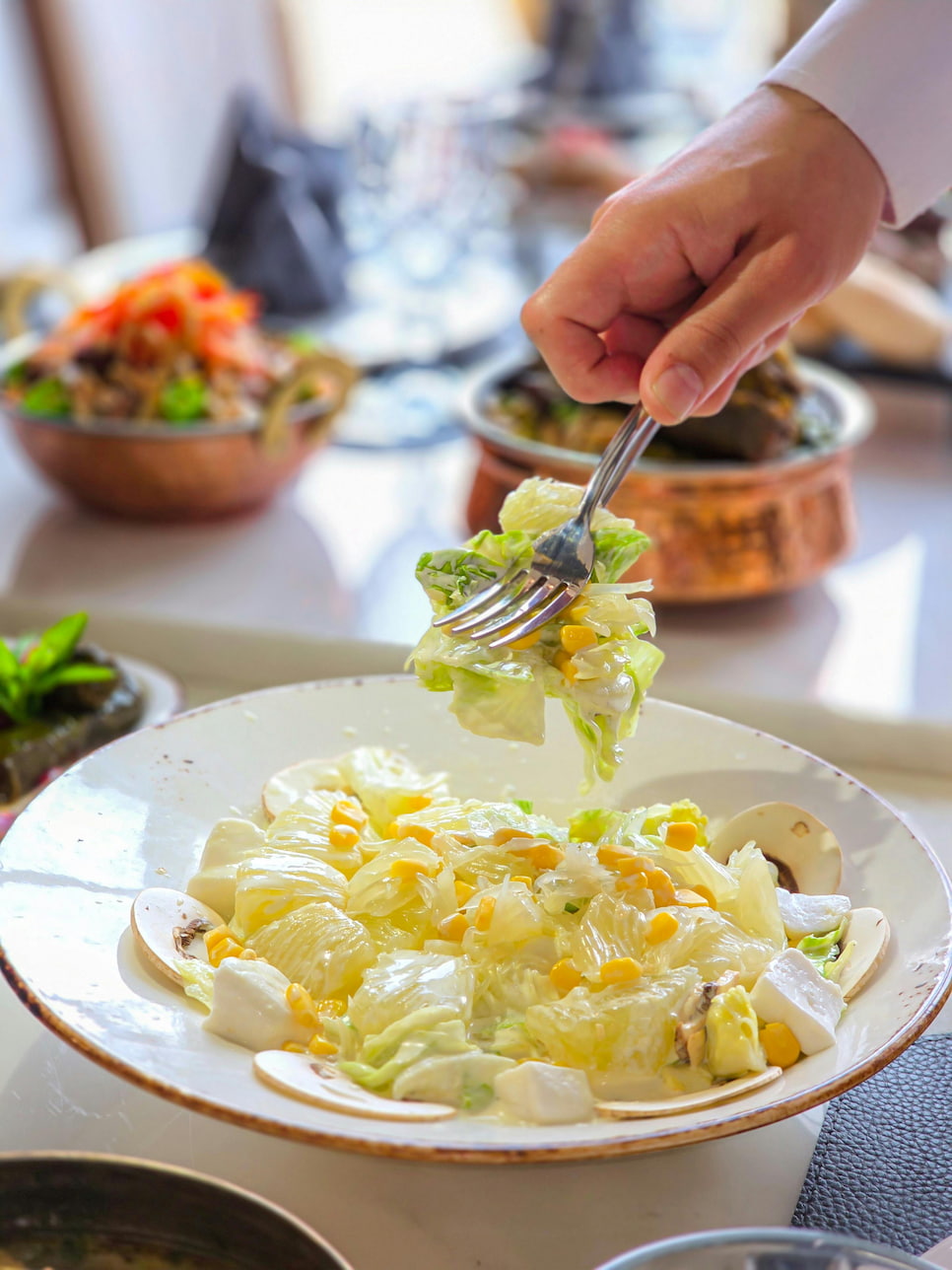 Chef plating a gourmet salad
